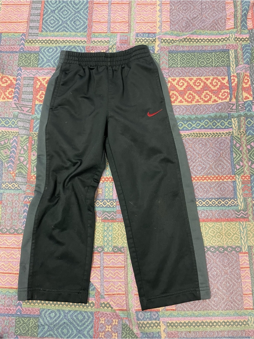Nike Kids Black Joggers with Gray Side Stripes and Red Swoosh